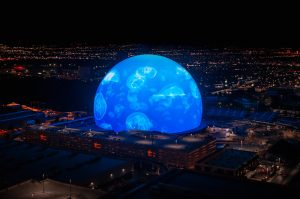 Concert at the Sphere in Las Vegas with vibrant lights and a futuristic atmosphere